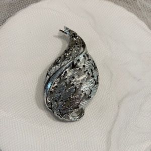 Vintage silver tone brooch with arrow shaped punch outs